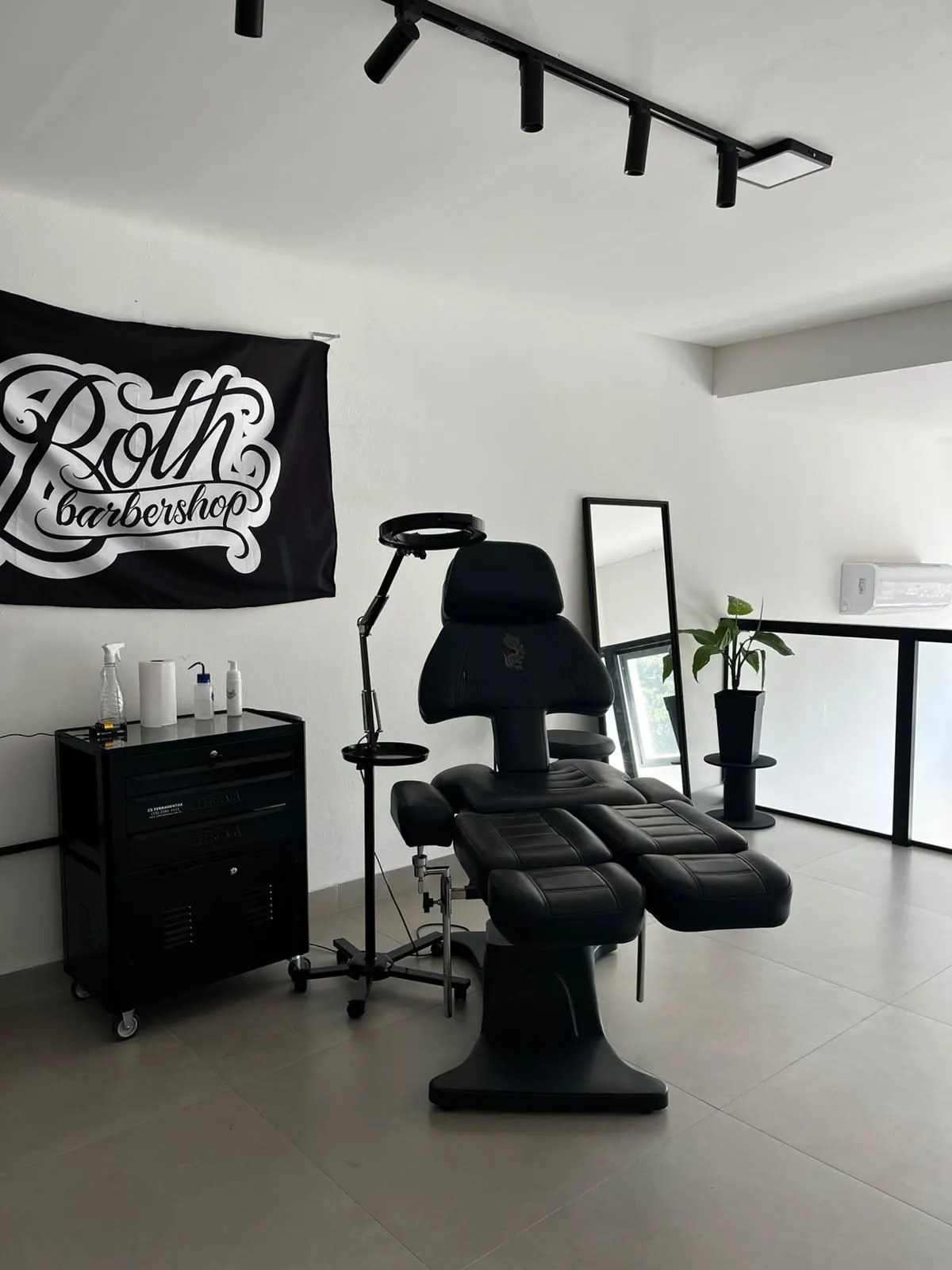 Mesmo mezanino pronto, com bandeira Both Barbershop e cadeira de tatuagem