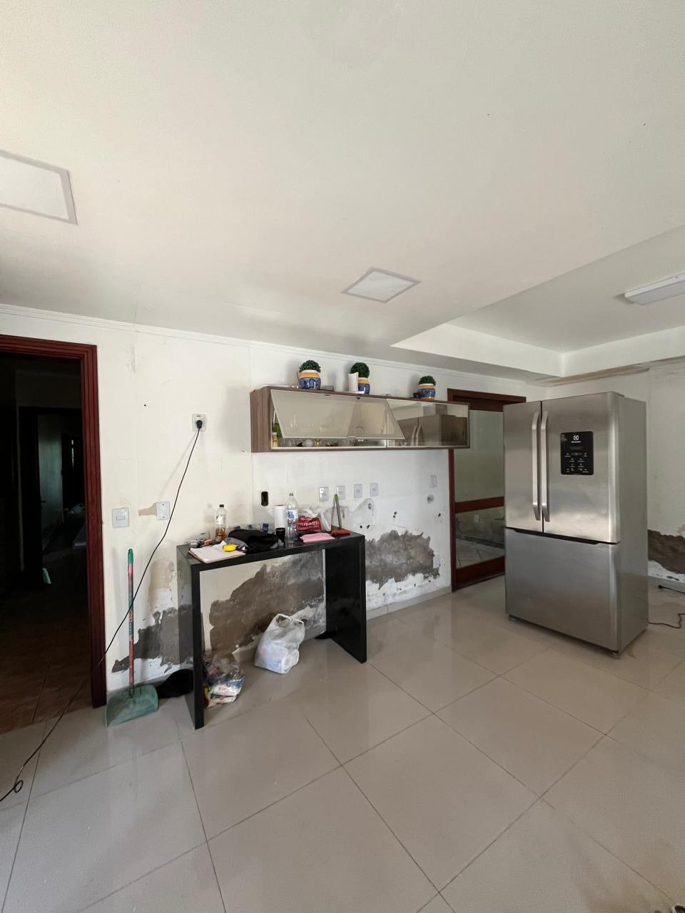 Canto da cozinha danificado pela enchente, com marcas de umidade na parede