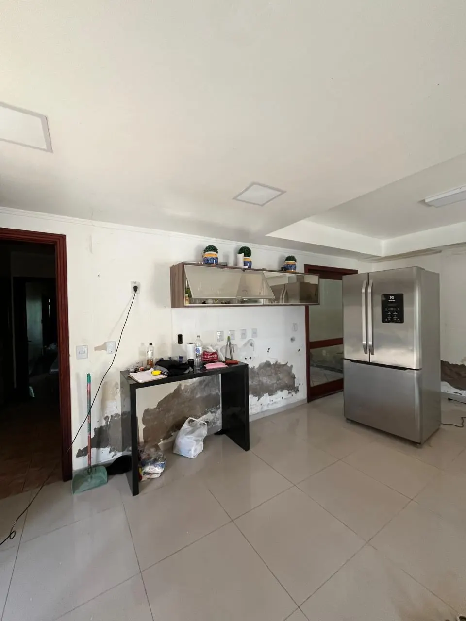 Canto da cozinha danificado pela enchente, com marcas de umidade na parede